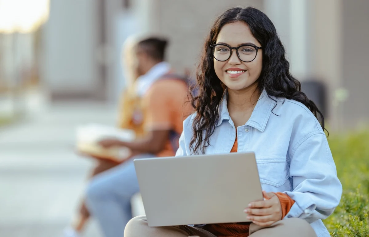 Supply Chain student sitting with laptop